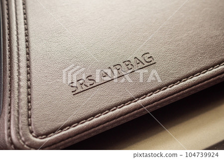 airbag safety sign on brown leather texture in modern car airbag safety sign on brown leather texture in modern car 104739924