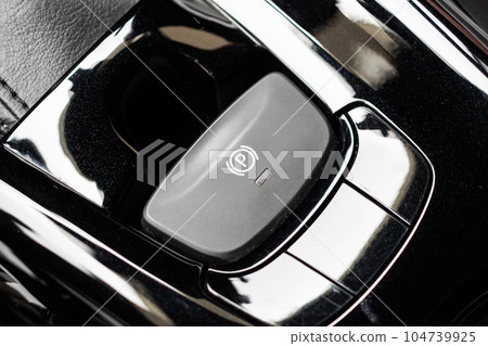 electronic handbrake button in luxury modern car electronic handbrake button in luxury modern car 104739925