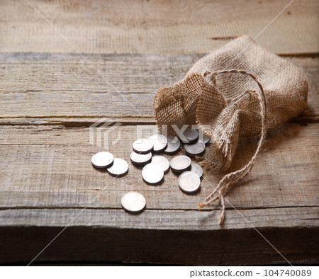 Thirty coins in a bag on the table 104740089