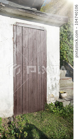 Old wooden door to a vintage dwelling Old wooden door to a vintage dwelling 104740106