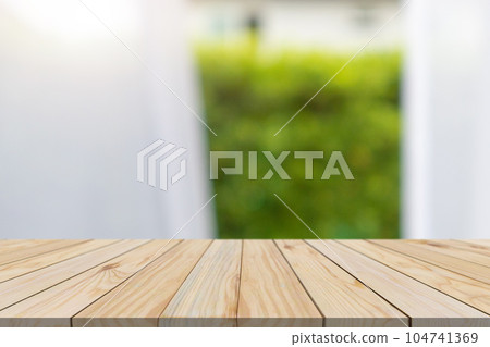 Empty wood table top with blur window curtain background for product display 104741369