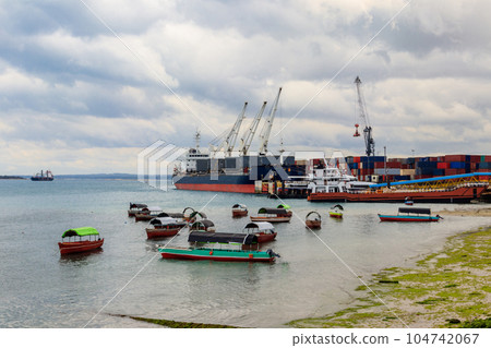 Port of Zanzibar with big ships, cranes and cargos near the quay in Stone Town, Zanzibar, Tanzania 104742067