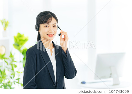 Female operator standing in the office Female operator standing in the office 104743099