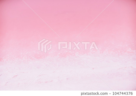 Woman in pink salt lake. She in a white dress and hat enjoys the scenic view of a pink salt lake as she walks along the white, salty shore, creating a lasting memory. Woman in pink salt lake. She in a white dress and hat enjoys the scenic view of a pink salt lake as she walks along the white, salty shore, creating a lasting memory. 104744376