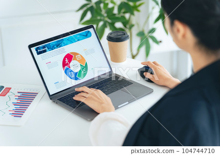 Woman using auto computer in office Woman using auto computer in office 104744710