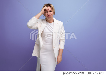 young pretty slim blond boss woman in elegant jacket and dress emotionally thinks about work 104745370