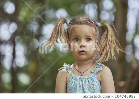 Adorable surprised child in the garden in Denmark 104745982