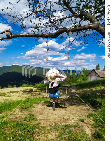 woman traveler enjoying of swinging on heavenly swing and mountain view woman traveler enjoying of swinging on heavenly swing and mountain view 104746048