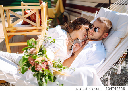 Newlyweds tenderly hug, kiss and enjoy each other in rv, camping in a trailer. Wedding. Love. 104746238