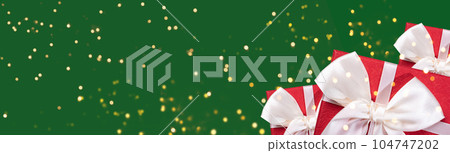 Christmas or New Year green background. Top view on red gift boxes and sparks bokeh. Banner, frame, format. flat lay with copy space. greeting card holidays concept. Christmas or New Year green background. Top view on red gift boxes and sparks bokeh. Banner, frame, format. flat lay with copy space. greeting card holidays concept. 104747202
