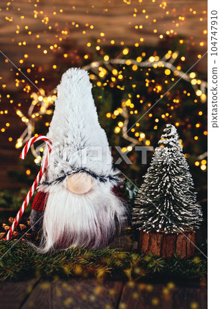 Merry christmas. Christmas composition with gnome and festive decorations on wooden background. Christmas or New Year greeting card. Noel gnome background. Christmas symbol. Happy Holidays. Merry christmas. Christmas composition with gnome and festive decorations on wooden background. Christmas or New Year greeting card. Noel gnome background. Christmas symbol. Happy Holidays. 104747910