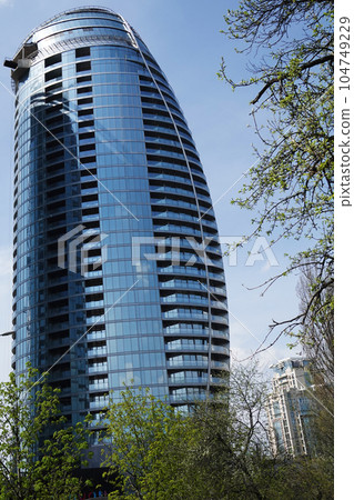 Kiev, Ukraine May 1, 2021: City high-rise building in the form of a sail in the center of Kiev Kiev, Ukraine May 1, 2021: City high-rise building in the form of a sail in the center of Kiev 104749229