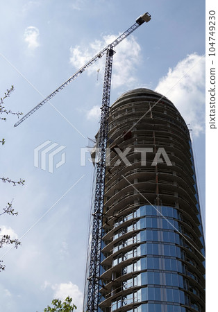 Kiev, Ukraine May 1, 2021: City high-rise building in the form of a sail in the center of Kiev Kiev, Ukraine May 1, 2021: City high-rise building in the form of a sail in the center of Kiev 104749230