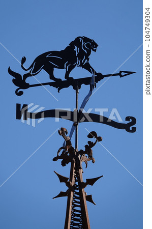 Kiev, Ukraine October 26, 2021: weather vane "Lion" on the spire of the film studio "Victoria film" Ukraine Kiev, Ukraine October 26, 2021: weather vane "Lion" on the spire of the film studio "Victoria film" Ukraine 104749304