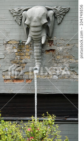 Kiev, Ukraine June 10, 2021: The facade of the building "House with Chimeras" its architectural decoration with sculptures and sculptures of animals and demons Kiev, Ukraine June 10, 2021: The facade of the building "House with Chimeras" its architectural decoration with sculptures and sculptures of animals and demons 104749856