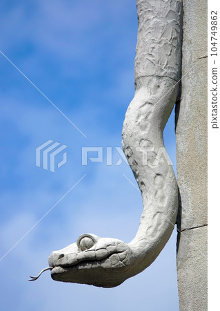 Kiev, Ukraine June 10, 2021: The facade of the building "House with Chimeras" its architectural decoration with sculptures and sculptures of animals and demons Kiev, Ukraine June 10, 2021: The facade of the building "House with Chimeras" its architectural decoration with sculptures and sculptures of animals and demons 104749862