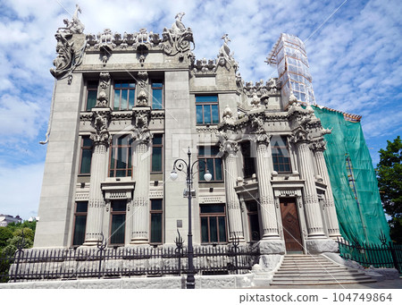 Kiev, Ukraine June 10, 2021: The facade of the building "House with Chimeras" its architectural decoration with sculptures and sculptures of animals and demons 104749864