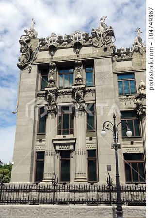 Kiev, Ukraine June 10, 2021: The facade of the building "House with Chimeras" its architectural decoration with sculptures and sculptures of animals and demons 104749867