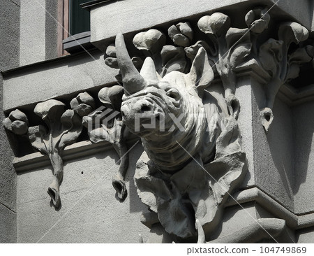 Kiev, Ukraine June 10, 2021: The facade of the building "House with Chimeras" its architectural decoration with sculptures and sculptures of animals and demons 104749869