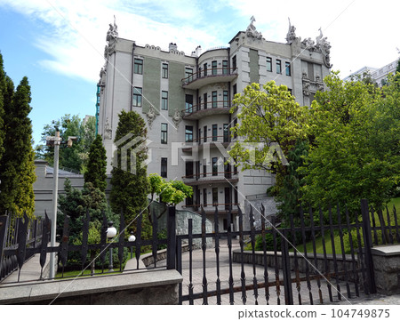 Kiev, Ukraine June 10, 2021: The facade of the building "House with Chimeras" its architectural decoration with sculptures and sculptures of animals and demons 104749875