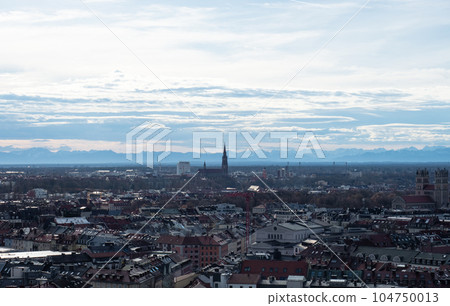 Munich, Germany - December 31st 2022: Aerial view over the historic city centre towards the Alps Munich, Germany - December 31st 2022: Aerial view over the historic city centre towards the Alps 104750013