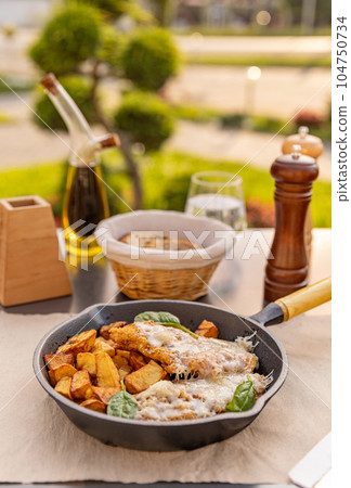 Veal schnitzel with grated cheese Veal schnitzel with grated cheese 104750734