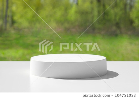 Podium for presentation. Blurred green grass background. Abstract geometrical form. Cylinder stone sphere. Shadow. Scene to show products. Showcase, display case. Trendy sunlight. Front view. 3D Podium for presentation. Blurred green grass background. Abstract geometrical form. Cylinder stone sphere. Shadow. Scene to show products. Showcase, display case. Trendy sunlight. Front view. 3D 104751058