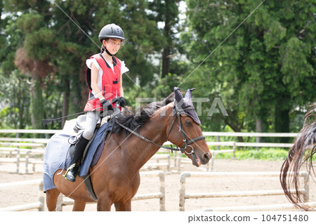 Kids enjoying horseback riding Kids enjoying horseback riding 104751480