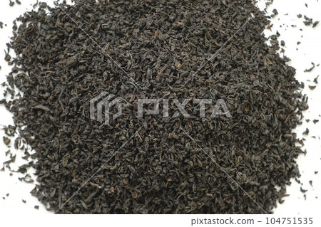 Pile of Black dry Tea on White. Black Tea Leaves. Close Up, Macro. Top View. Texture. Full Frame. Copy Space. Dried Tea. Abstract Food and Drink Background 104751535