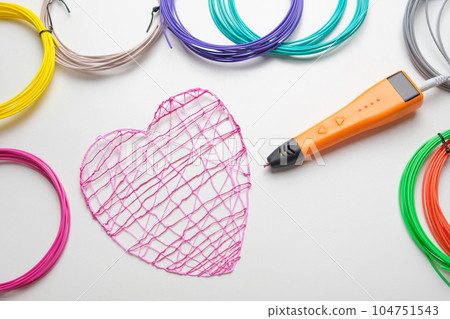 3d Pen. Printing with Colored Plastic Wire Filament. Child making a Christmas Three, Heart shape drawing with 3D pen. Artwork, Robotics. STEAM, STEM education. Modern Technologies. Study at home 104751543