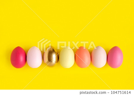 Easter banner with colorful Easter Egg in a row. Border over a yellow background. Above view with copy space. Happy Easter card. Top view, flatlay Easter banner with colorful Easter Egg in a row. Border over a yellow background. Above view with copy space. Happy Easter card. Top view, flatlay 104751614