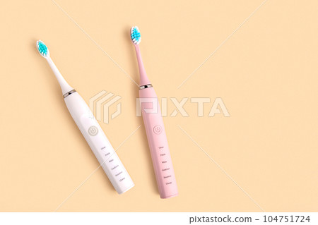 Electric Toothbrush. Top View, Flat Lay, Copy Space. Dental Care Supplies on Beige Pastel Studio Background. Oral Hygiene, Gum Health, Healthy Teeth. Modern Dental Ultrasonic Vibration Tooth Brush Set Electric Toothbrush. Top View, Flat Lay, Copy Space. Dental Care Supplies on Beige Pastel Studio Background. Oral Hygiene, Gum Health, Healthy Teeth. Modern Dental Ultrasonic Vibration Tooth Brush Set 104751724