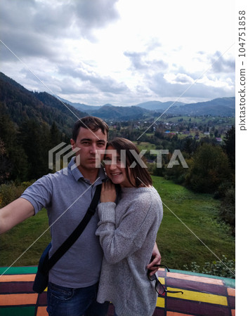 couple of travelers making selfie with mountain view 104751858