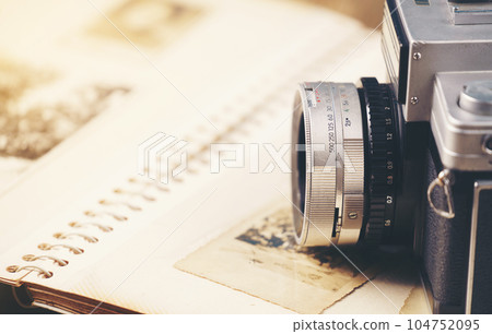 retro camera on the background of old photos retro camera on the background of old photos 104752095