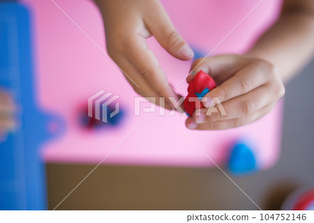 Cute child's hands playing with clay 104752146