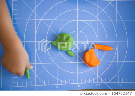 Cute child's hands playing with clay 104752147