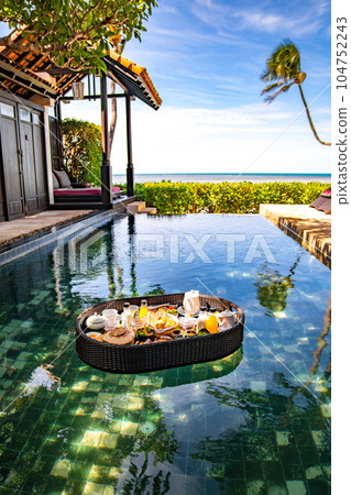 Floating breakfast in pool in Lamai beach resort in Koh Samui, Thailand Floating breakfast in pool in Lamai beach resort in Koh Samui, Thailand 104752243