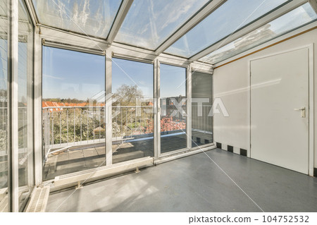 a room with large windows and a view of the city outside, taken from inside an open air conditioning unit a room with large windows and a view of the city outside, taken from inside an open air conditioning unit 104752532