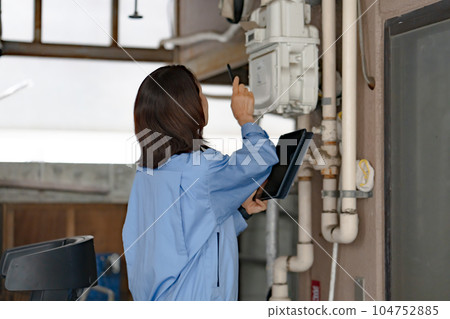 Woman in work clothes Inspection Meter reading 104752885