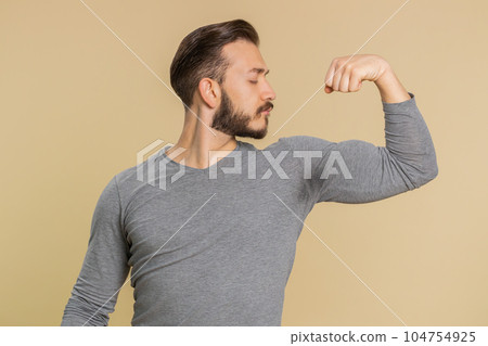 Fit sporty lebanese man showing biceps and looking confident, feeling power strength success win 104754925