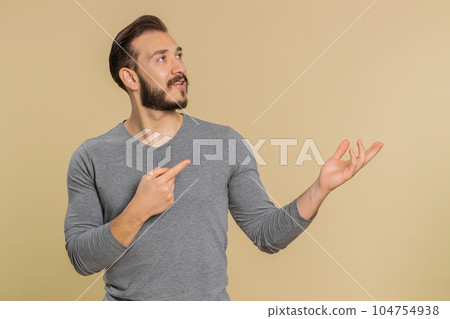 Lebanese man showing thumbs up and pointing empty blank place, advertising area for commercial text 104754938