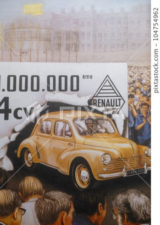 19 April 2023 Paris, France. Photo of a poster celebrating production of one million Renault 4cv showing a yellow car breaking through a paper banner while crowds of people cheer. Factory workers 19 April 2023 Paris, France. Photo of a poster celebrating production of one million Renault 4cv showing a yellow car breaking through a paper banner while crowds of people cheer. Factory workers 104754962