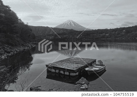 Mount fuji and floating boat on Lake Saiko with skyline reflection 104755519