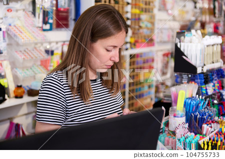 Portrait of a Caucasian serious sales manager, seller standing at counter in office supply store. School stationery shop 104755733