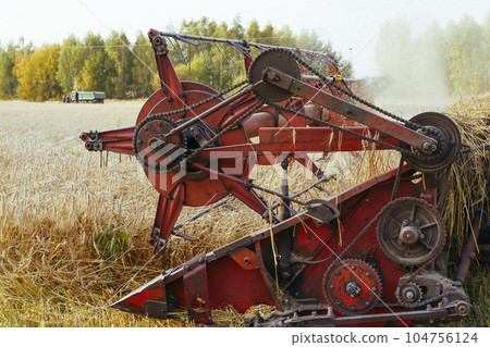 Combine harvester on the wheat field 104756124