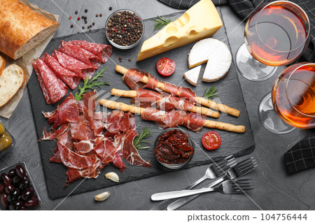 Tasty prosciutto served on grey table, flat lay 104756444