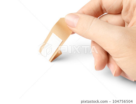 Woman putting sticking plaster on white background. First aid item Woman putting sticking plaster on white background. First aid item 104756504
