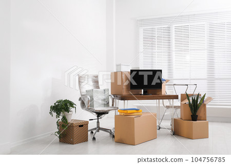 Cardboard boxes and packed belongings in office. Moving day 104756785