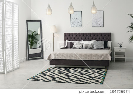 Elegant interior of modern comfortable bedroom with mirror 104756974