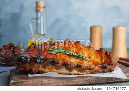 Tasty grilled ribs with rosemary on table 104756977
